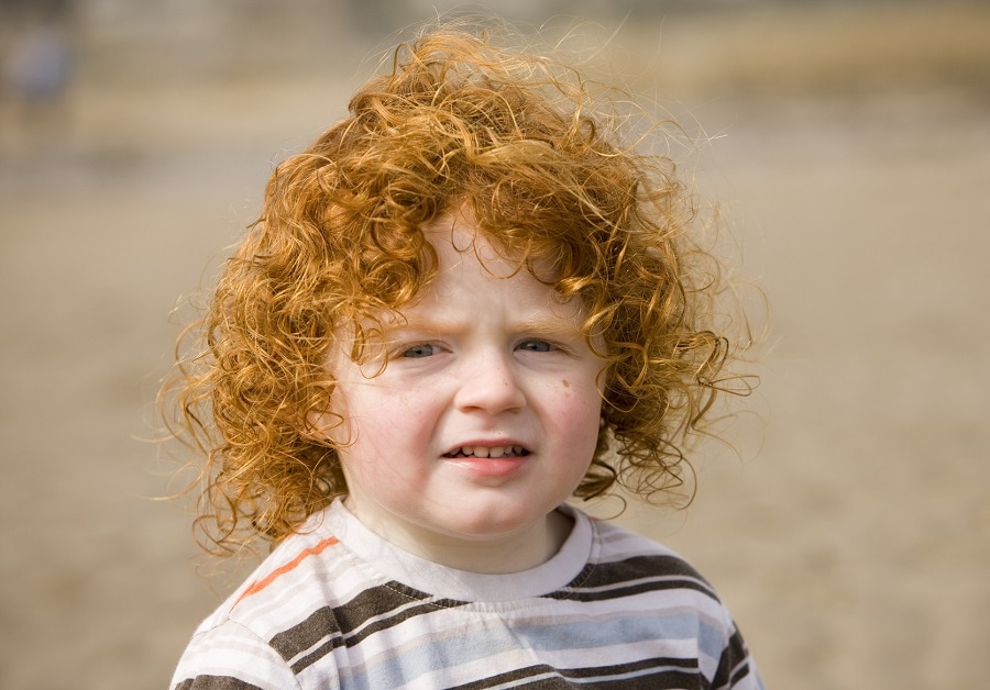 toddler boy with long red curly hair