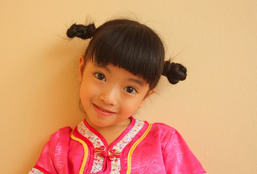 little Asian girl space buns with bangs