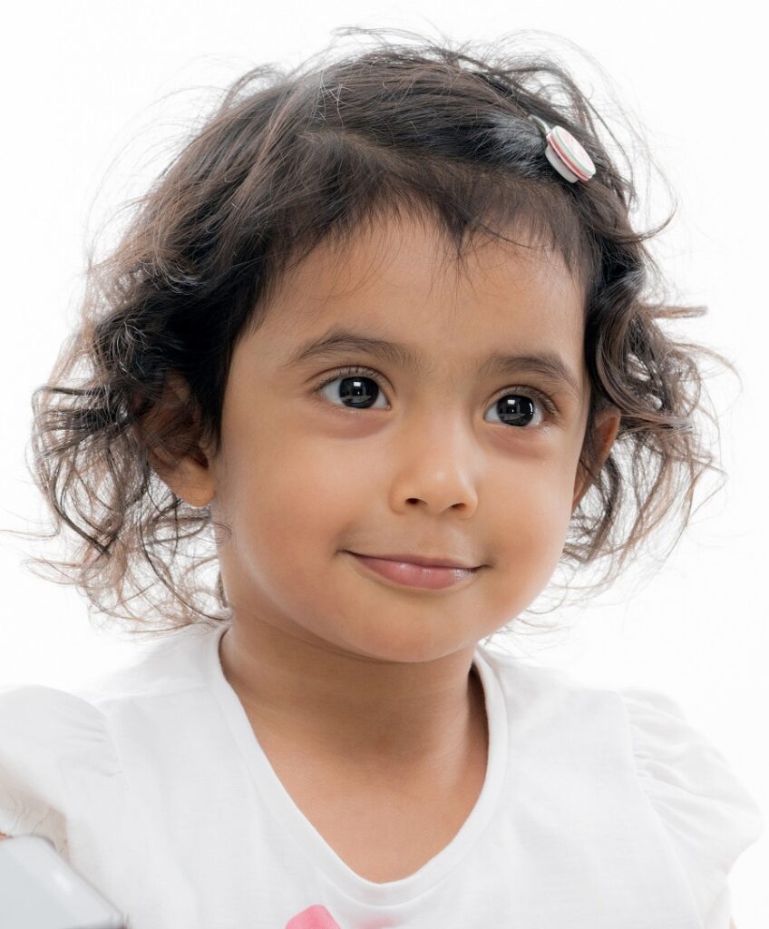 Indian baby girl with layered curly hairstyle